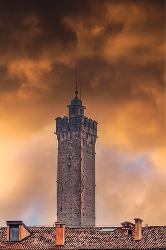 Bologna, Italy Asinelli Tower, part of Due Torri, medieval Two Towers city symbol, against dramatic orange clouds.