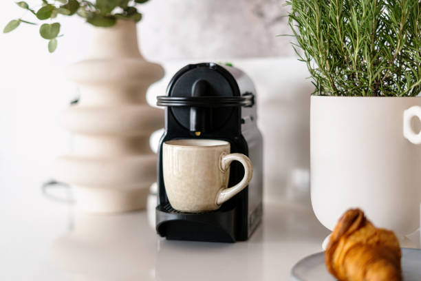 istock Freshly brewed latte poured from the coffee machine into cup 1489110947