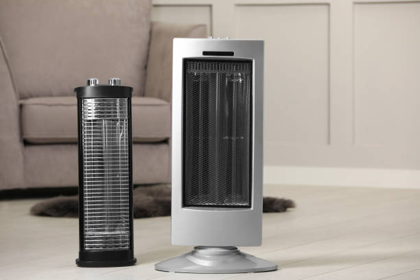 istock Different modern infrared heater on floor in cozy room 1489112195
