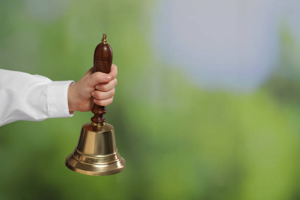 Pupil with school bell outdoors, closeup. Space for text Pupil with school bell outdoors, closeup. Space for text school handbell stock pictures, royalty-free photos & images