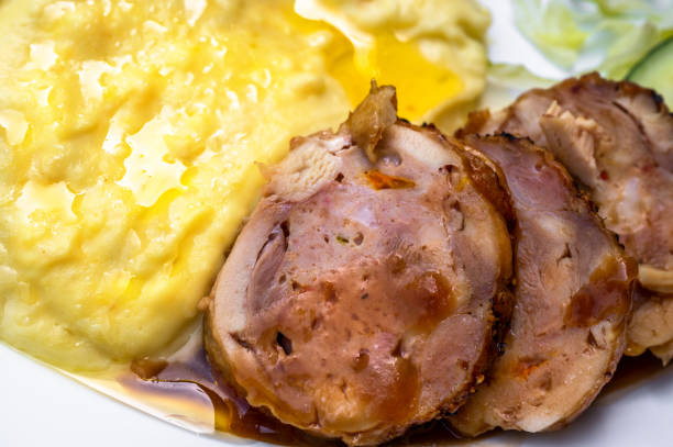 Detail of mashed potato with chicken meat roulade with cheese and cranberries. stock photo