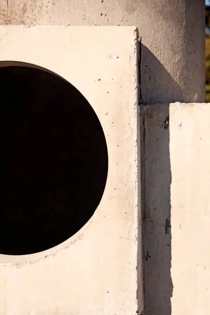 concrete wall with large round hole for a window