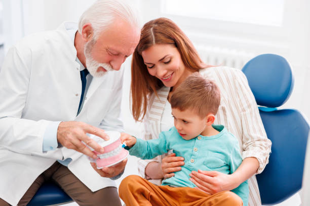 istock Dentist educating child how to brush teeth properly 1489114745