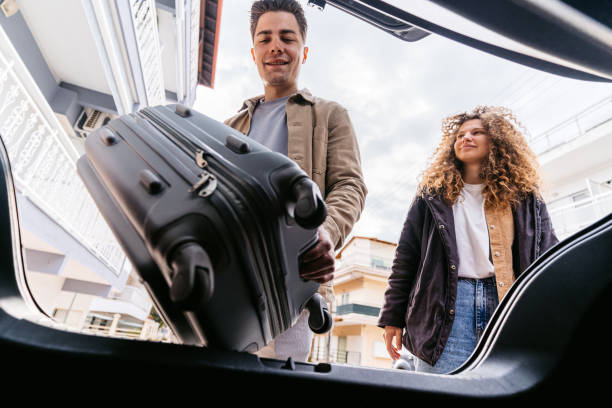 istock Young Couple Putting Luggage In Their Car 1489114875