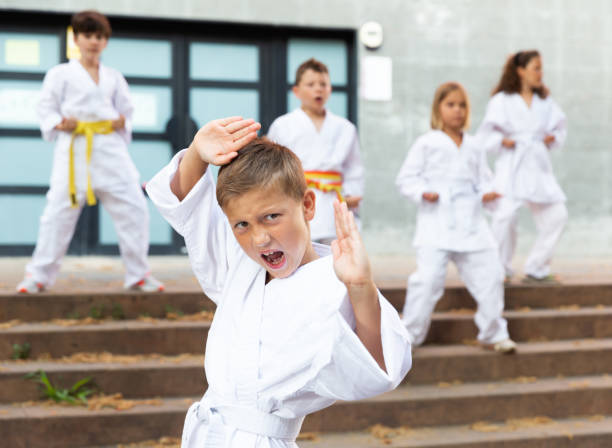 istock Preteen boy practicing karate at schoolyard 1489115600
