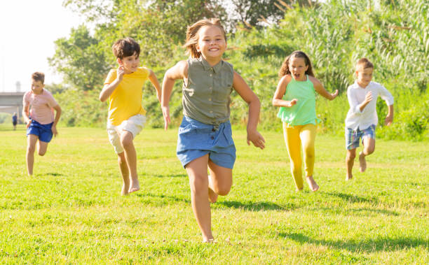 istock Children running on green grass 1489116166