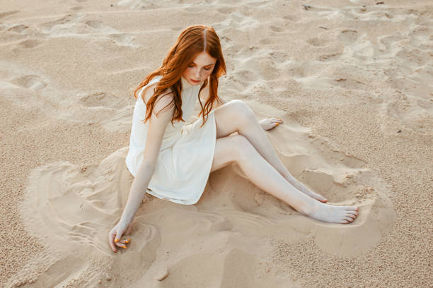 istock Slim redhead woman relaxing on beach in summer 1489121807