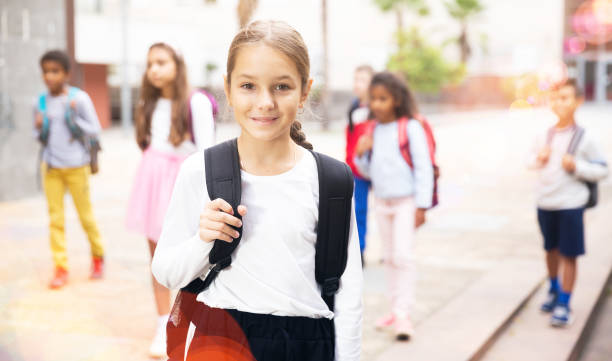 istock Tweenager girl with backpack walking after lessons 1489121920