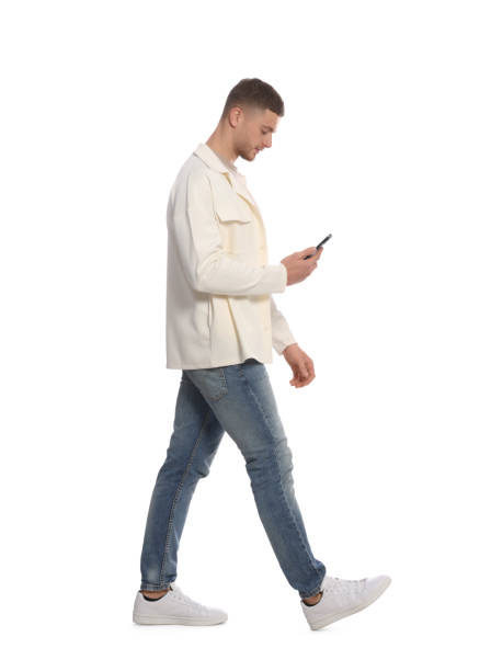 istock Man with smartphone walking on white background 1489124339