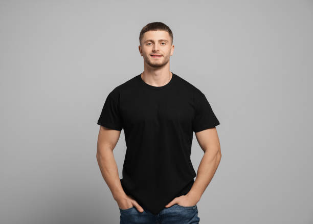istock Man wearing black t-shirt on light grey background. Mockup for design 1489124598