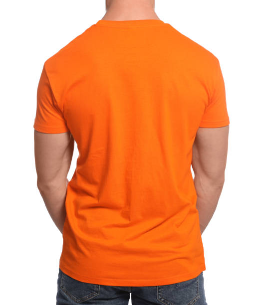 istock Man wearing orange t-shirt on white background, back view. Mockup for design 1489125876