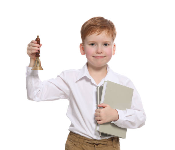 istock Pupil with school bell and books on white background 1489126119