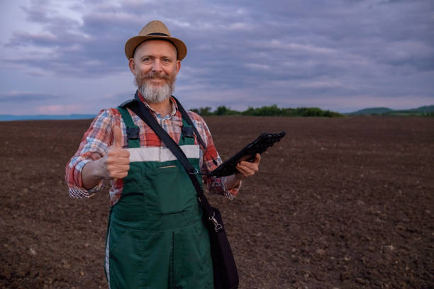 istock A farmer in a plowed field before sunrise. 1489126851