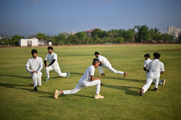 istock Team players performing warm up exercises before cricket match 1489128265