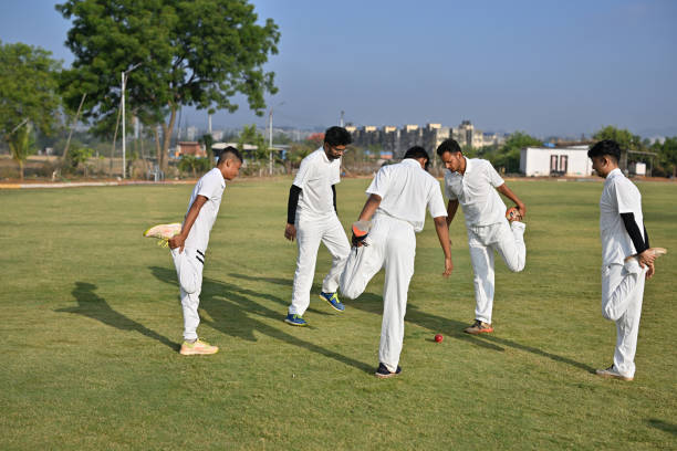 istock Team players performing warm up exercises before cricket match 1489128309