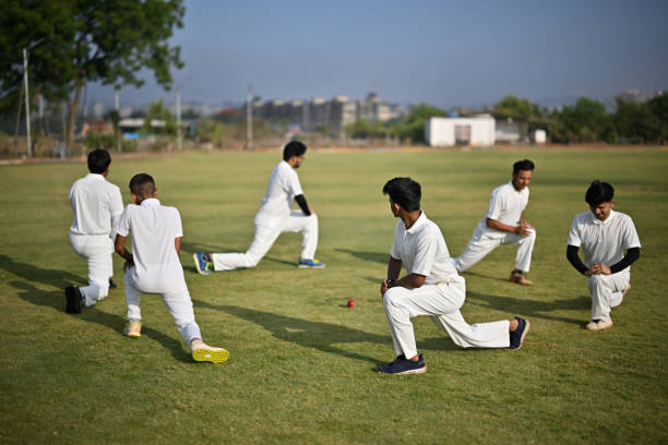 istock Team players performing warm-up exercises before cricket match 1489128317