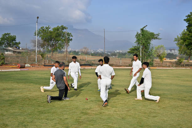 istock Team players performing warm up exercises along with coach before cricket match 1489128407
