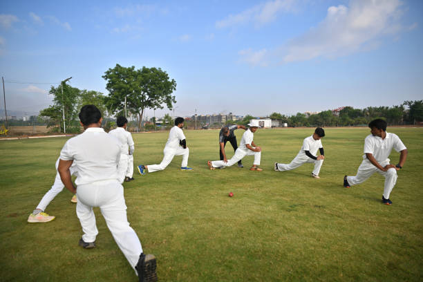 istock Coach helping team players during warm-up routine before cricket match 1489128652