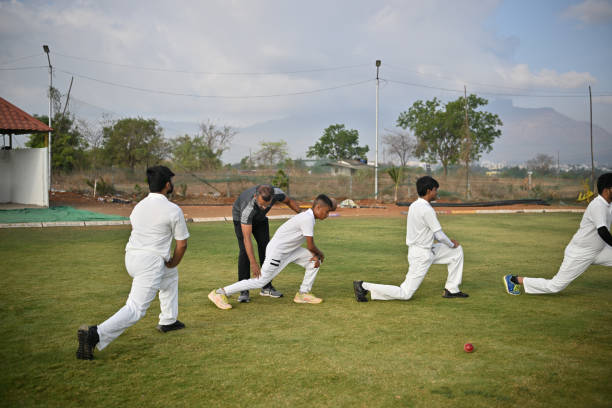 istock Coach helping team players during warm-up routine before cricket match 1489128671
