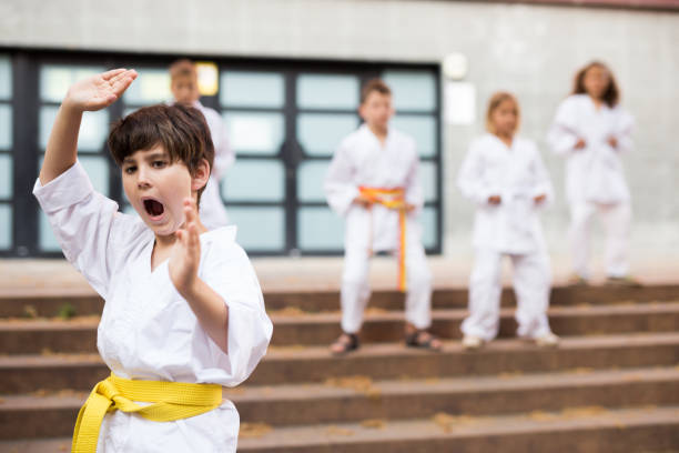 istock Preteen boy practicing karate at schoolyard 1489129136