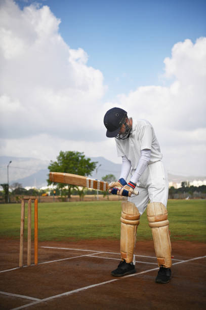 istock Cricket batsman on the field, warming up before the match 1489129320