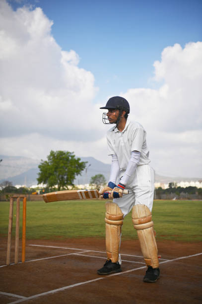 Cricket batsman on the field, warming up before the match
