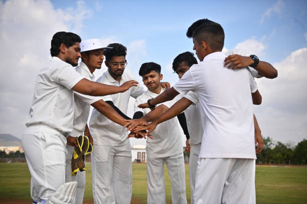 Young cricket team shouting the team slogan before entering the ground for match
