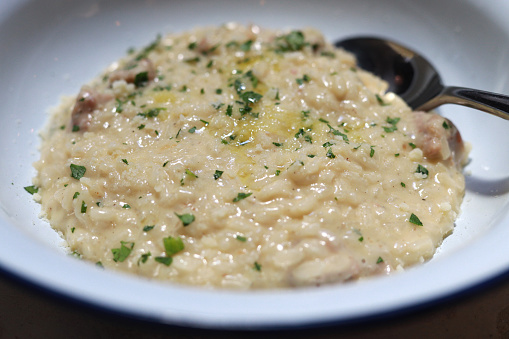 Risotto is a northern Italian rice dish cooked with broth until it reaches a creamy consistency.