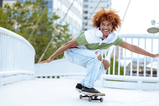 Cheerful man riding a skateboard