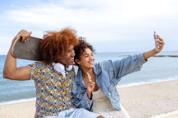 istock Young people taking selfie by the sea 1489131443