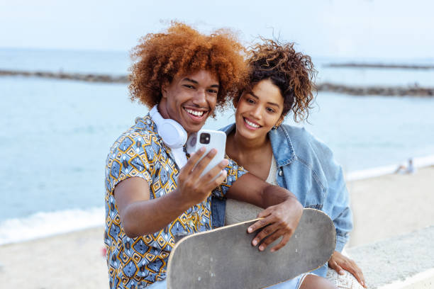 istock Young people taking selfie by the sea 1489131784