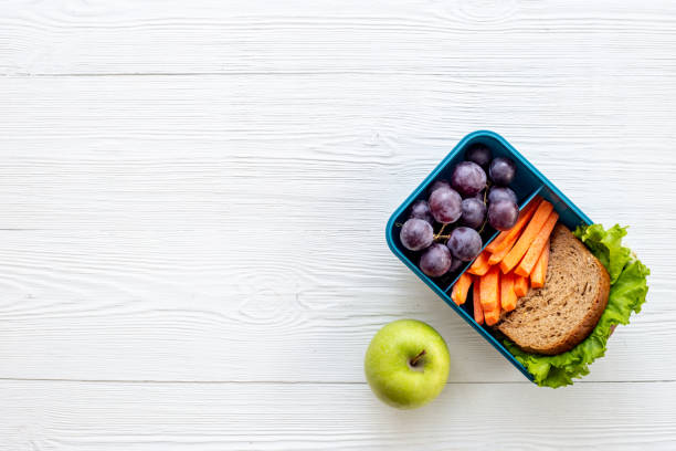 istock Lunch box set with bread fruits and vegetables, top view 1489138434
