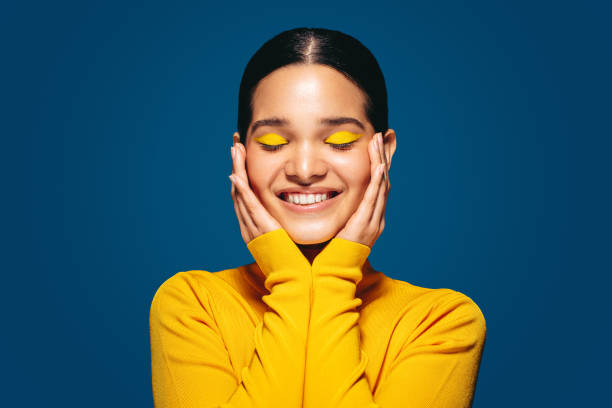 istock Empowered by makeup, confident young woman smiles as she embraces her face 1489139024