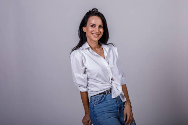 istock Confident woman sitting against white background, smiling happily 1489139242