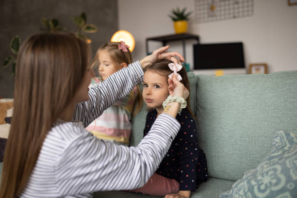 istock Mother doing her daughter's hair at home 1489139315