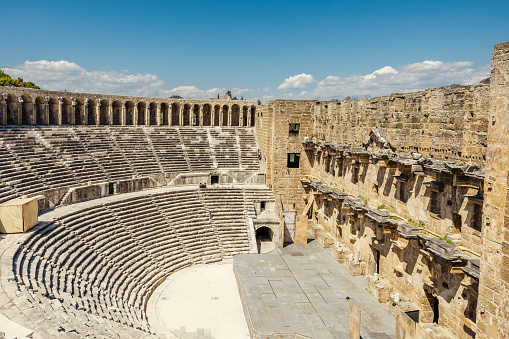 Wide-angle shot of Aspendos ancient theater, capturing the stage and audience stairs, displaying the grandeur of this historic site.