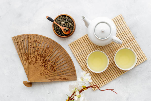 istock Asian tea ceremony with fan and cherry blossom branch 1489141407