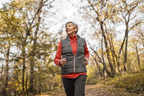 istock Senior woman jogging in park 1489141486