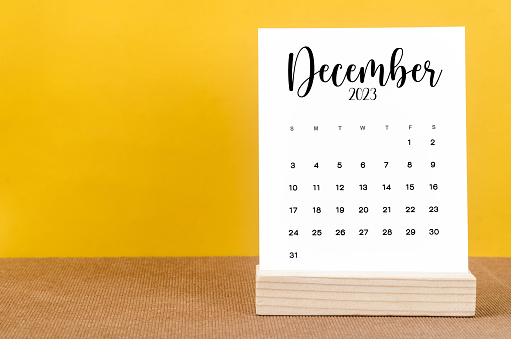 December 2023 Monthly calendar for 2023 year on yellow table.