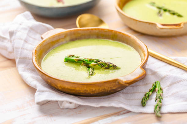 istock Creamy asparagus soup on wooden background 1489152835
