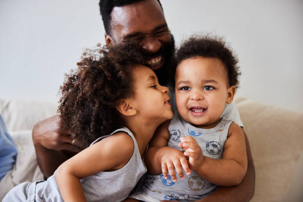 istock Dad playing with his little boys while sitting with his wife in bed 1489152930