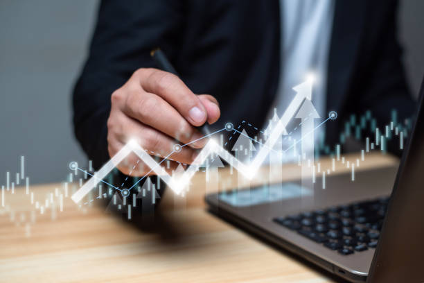 istock Business developmetn and tecnology concept. Businessman using laptop and pointing on technical growing up graph on virtual hologram display. Planning and strategy, Financial investment and trading. 1489153660
