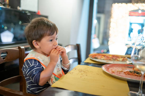 istock Toddler having a pizza in the restaurant on a dinner night out 1489155128
