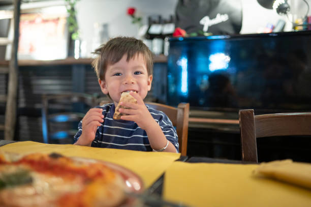 istock Toddler having a pizza in the restaurant on a dinner night out 1489155371