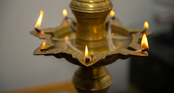 Brass Oil lamp illuminated before the opening ceremony close-up shot.