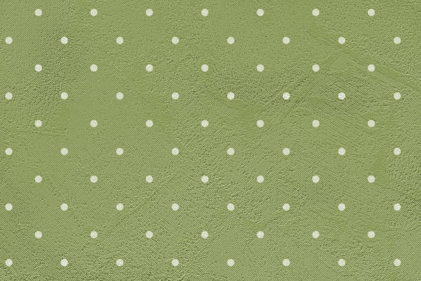 Green paper background with white polka dots.