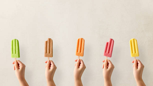 istock Hands holding different types of colorful fruit popsicles 1489160357