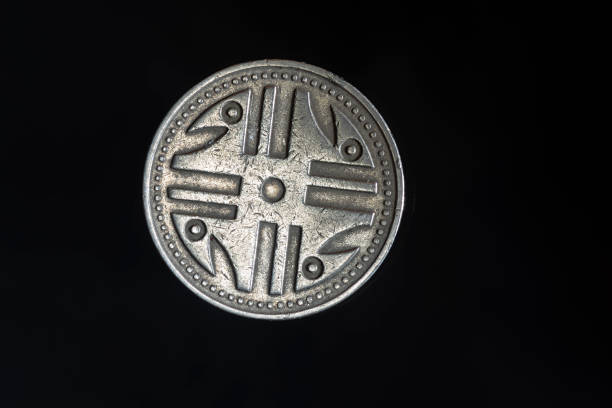 200 Colombian pesos coins on a black background close-up