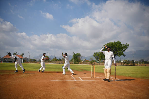 istock Cricket team players celebrating after taking wicket during cricket match 1489166406