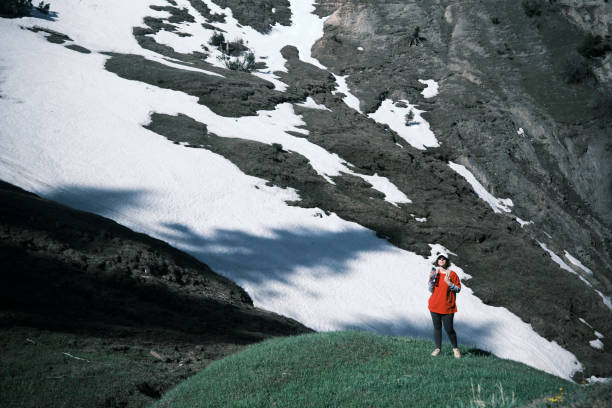 istock Female hiker is drinking water in mountains 1489166736